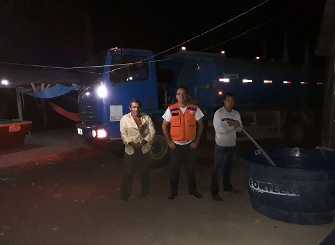 Caminhão pipa abastecendo reservatórios junto à presidencia da localidade